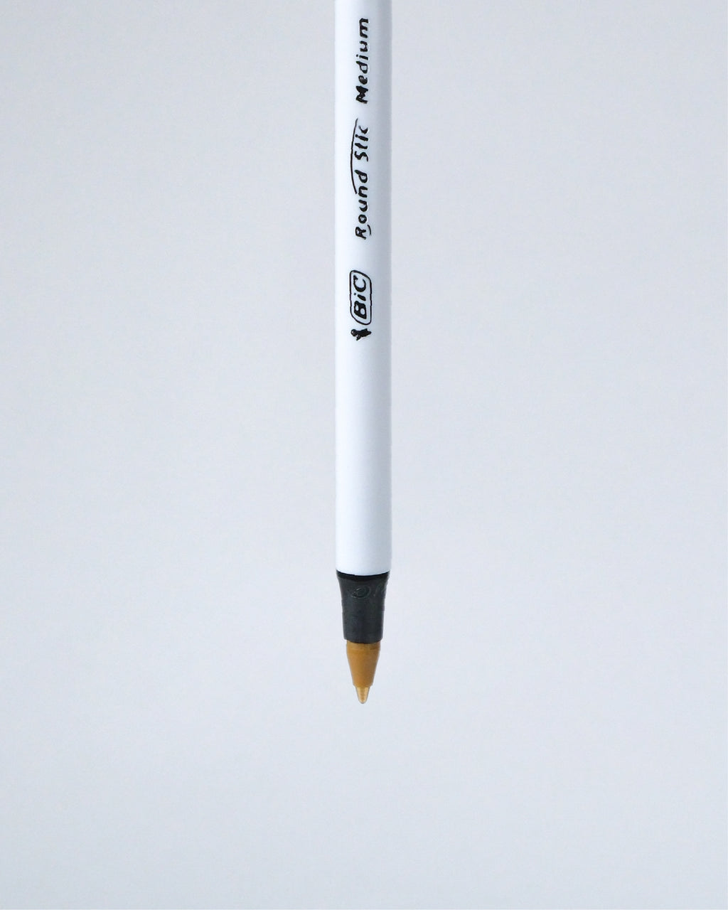 A single BIC Round Tip Medium pencil shown vertically against a light gray background.