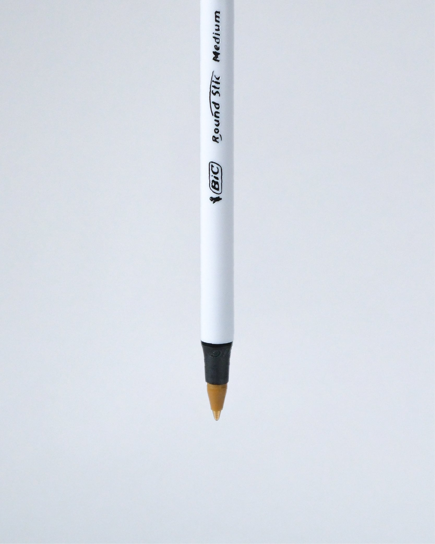 A single BIC Round Tip Medium pencil shown vertically against a light gray background.