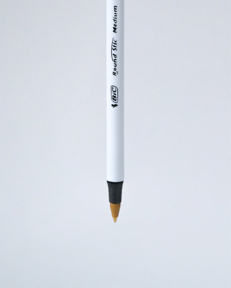 A single BIC Round Tip Medium pencil shown vertically against a light gray background.