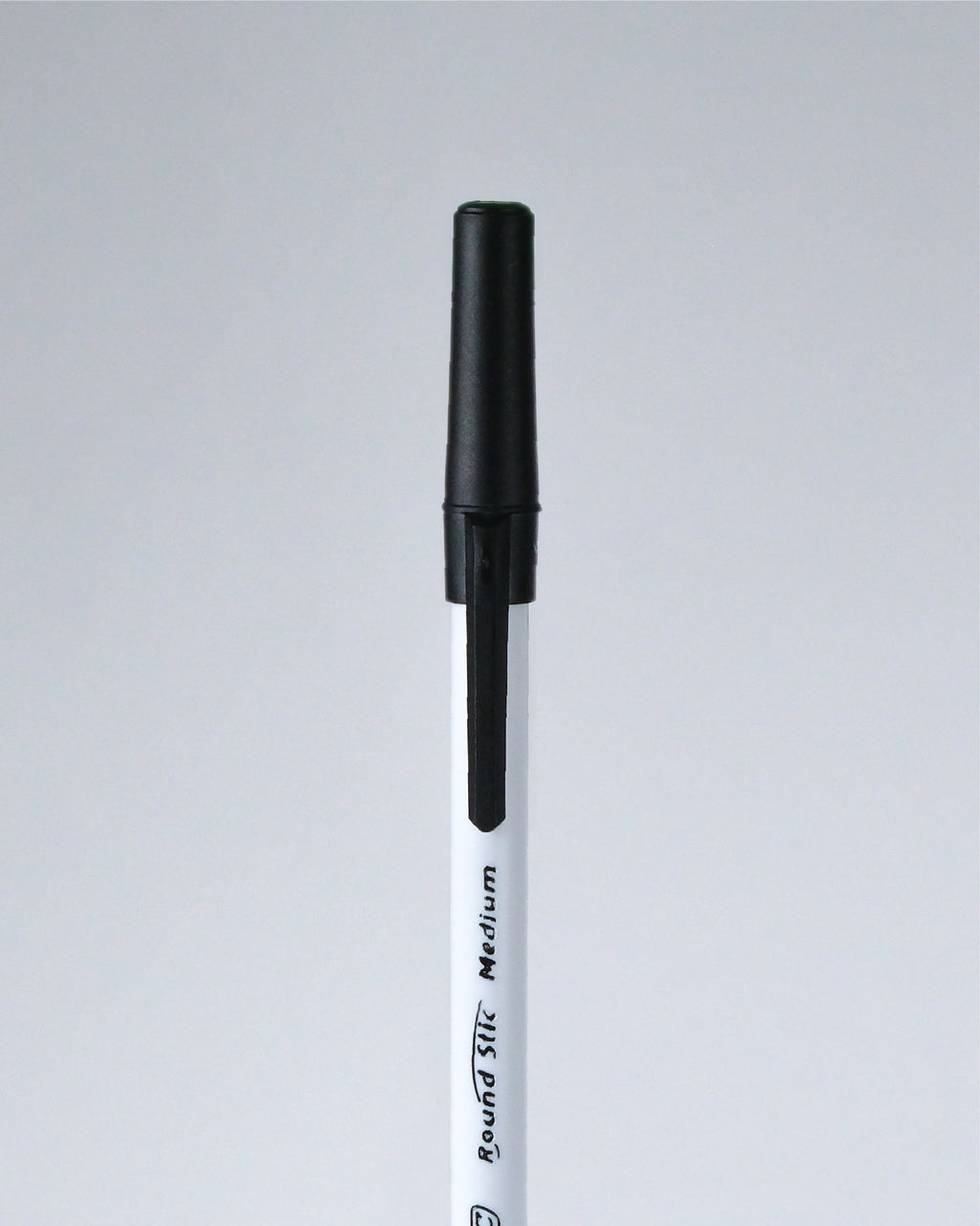 A single black and white marker pen shown vertically against a light gray background.