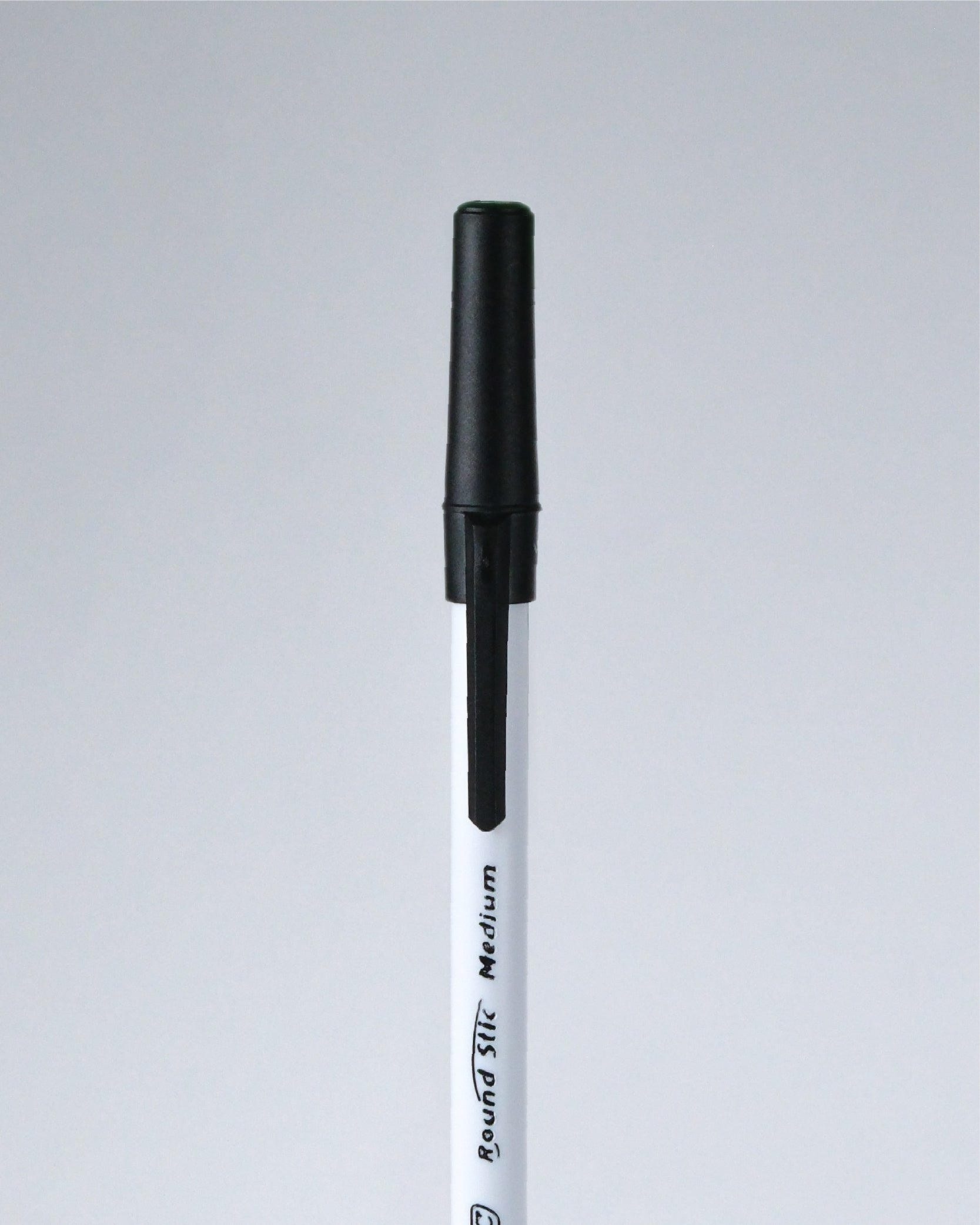 A single black and white marker pen shown vertically against a light gray background.