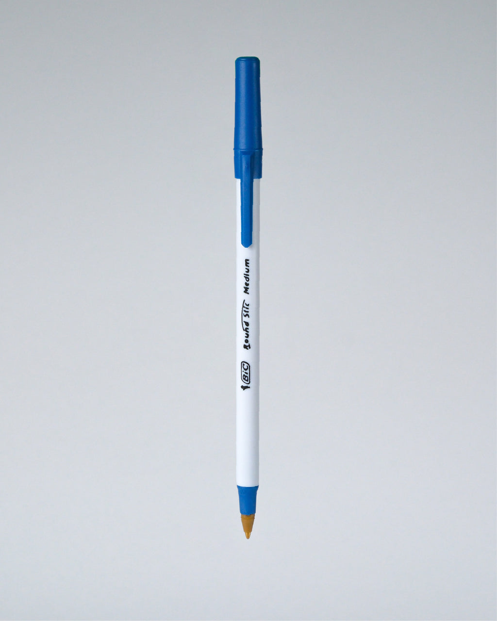 A blue and white Perfora ballpoint pen with a gold tip, shown vertically against a neutral gray gradient background.