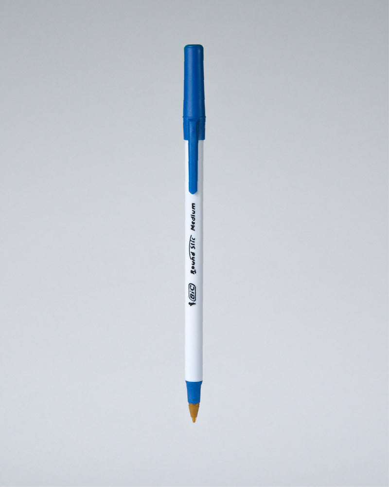 A blue and white Perfora ballpoint pen with a gold tip, shown vertically against a neutral gray gradient background.