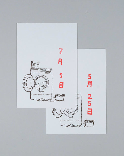 Two overlapping white greeting cards featuring minimalist black line drawings of washing machines and laundry baskets, with red Japanese text displaying dates, set against a solid gray background.