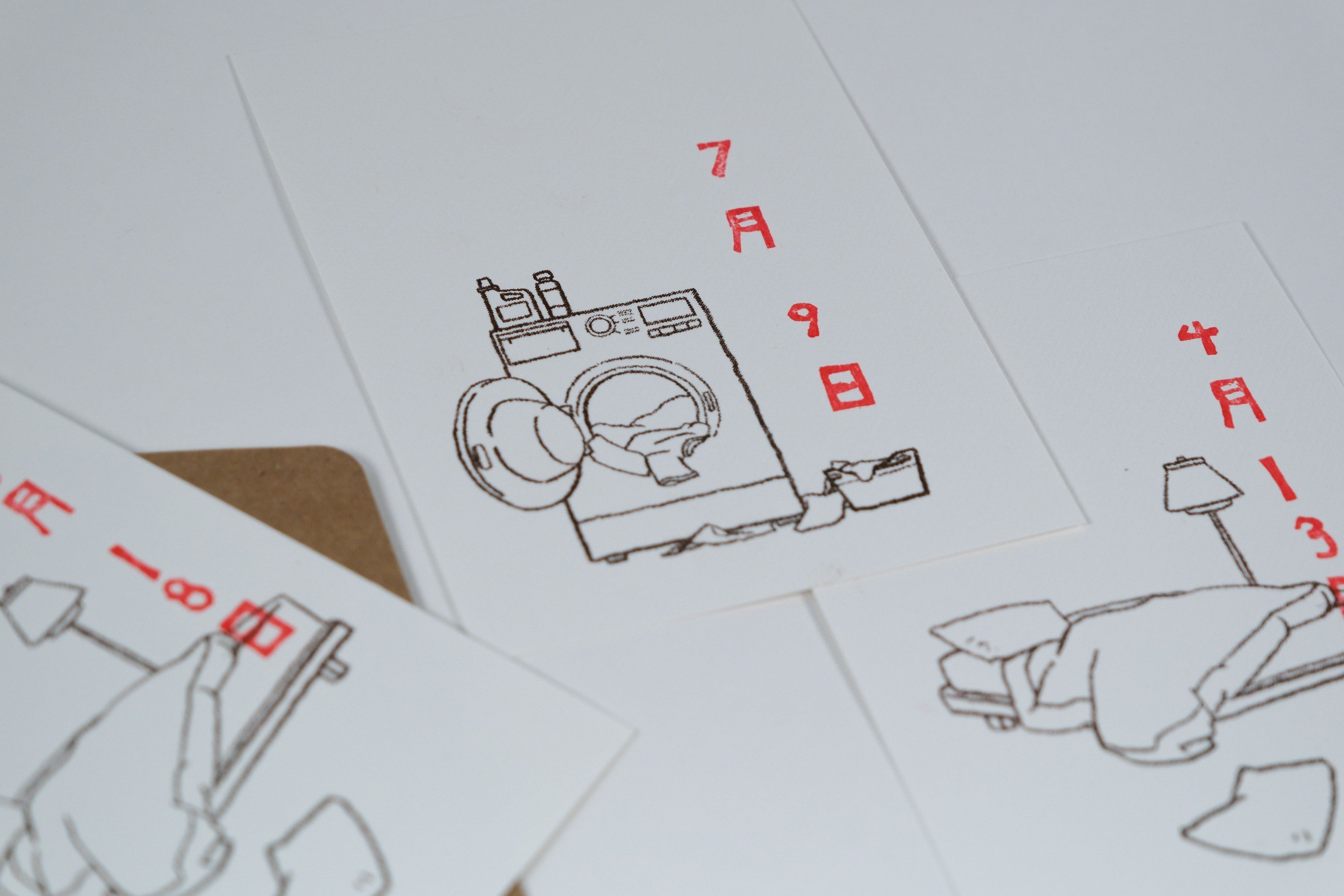 Set of playing cards with illustrations and red text on a white background