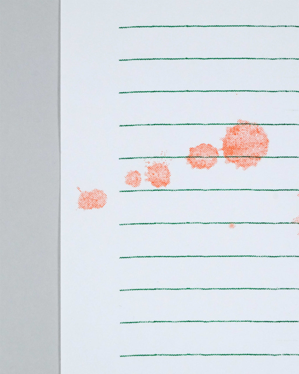 A close-up of a white lined notepad with green horizontal lines and several orange-red ink smudges on the right side, photographed against a light gray background.