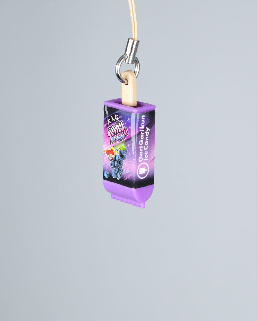 A purple and black ice cream-shaped keychain charm with a wooden stick and metal ring, labeled 'Fruity Blast' and 'Ice Cream', shown against a solid gray background.