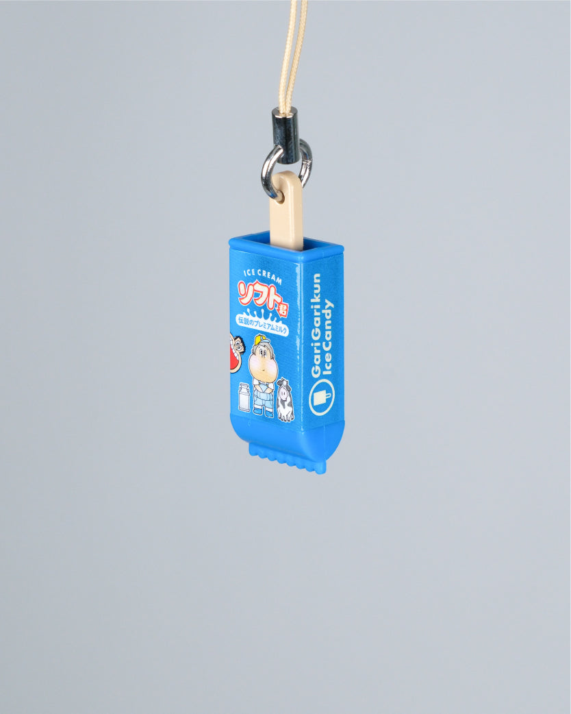 A blue novelty phone strap or lanyard charm shaped like an ice cream candy wrapper, hanging from a beige cord with a metal ring, shown against a solid light gray background.