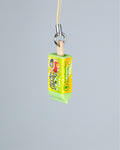 A small novelty keychain or phone charm shaped like a popsicle stick, with a light wood stick, silver metal ring, and beige cord. The wrapper is bright yellow and green with cartoon graphics and the text 'Gorocanica IceCandy' visible on the side.