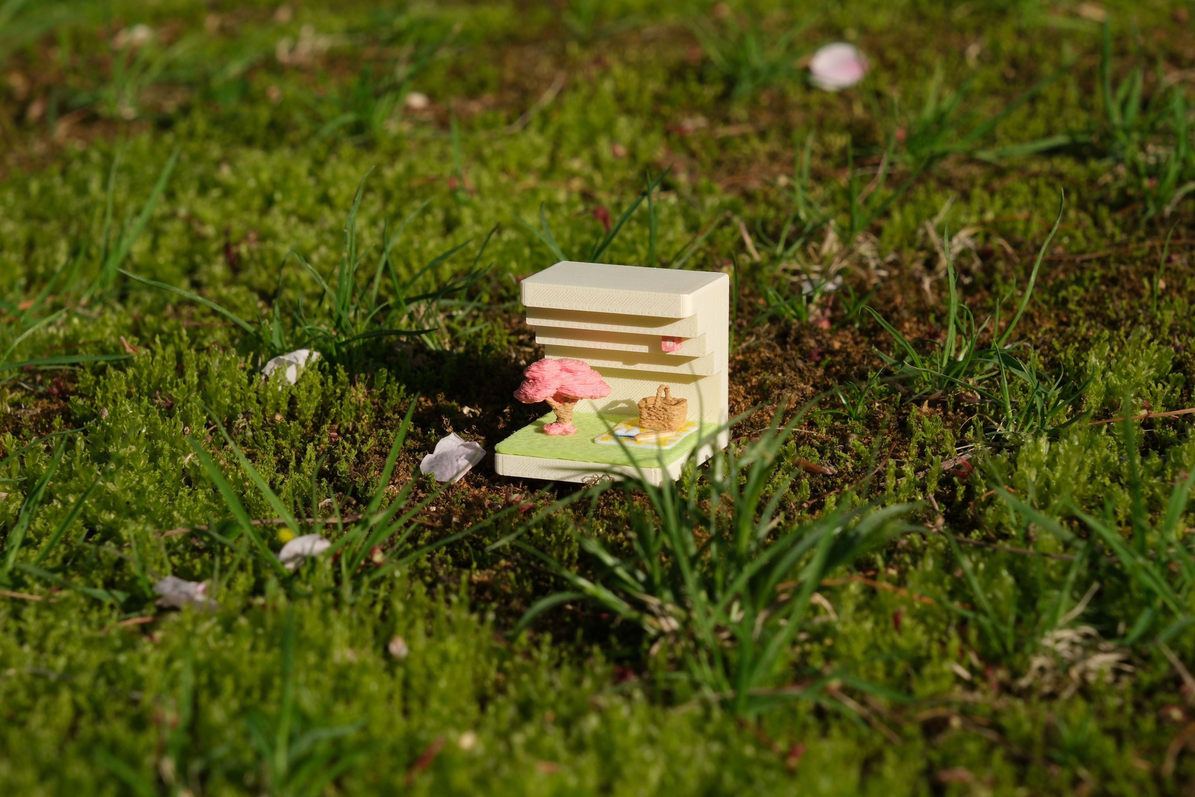 Small model of a house with a garden on grass