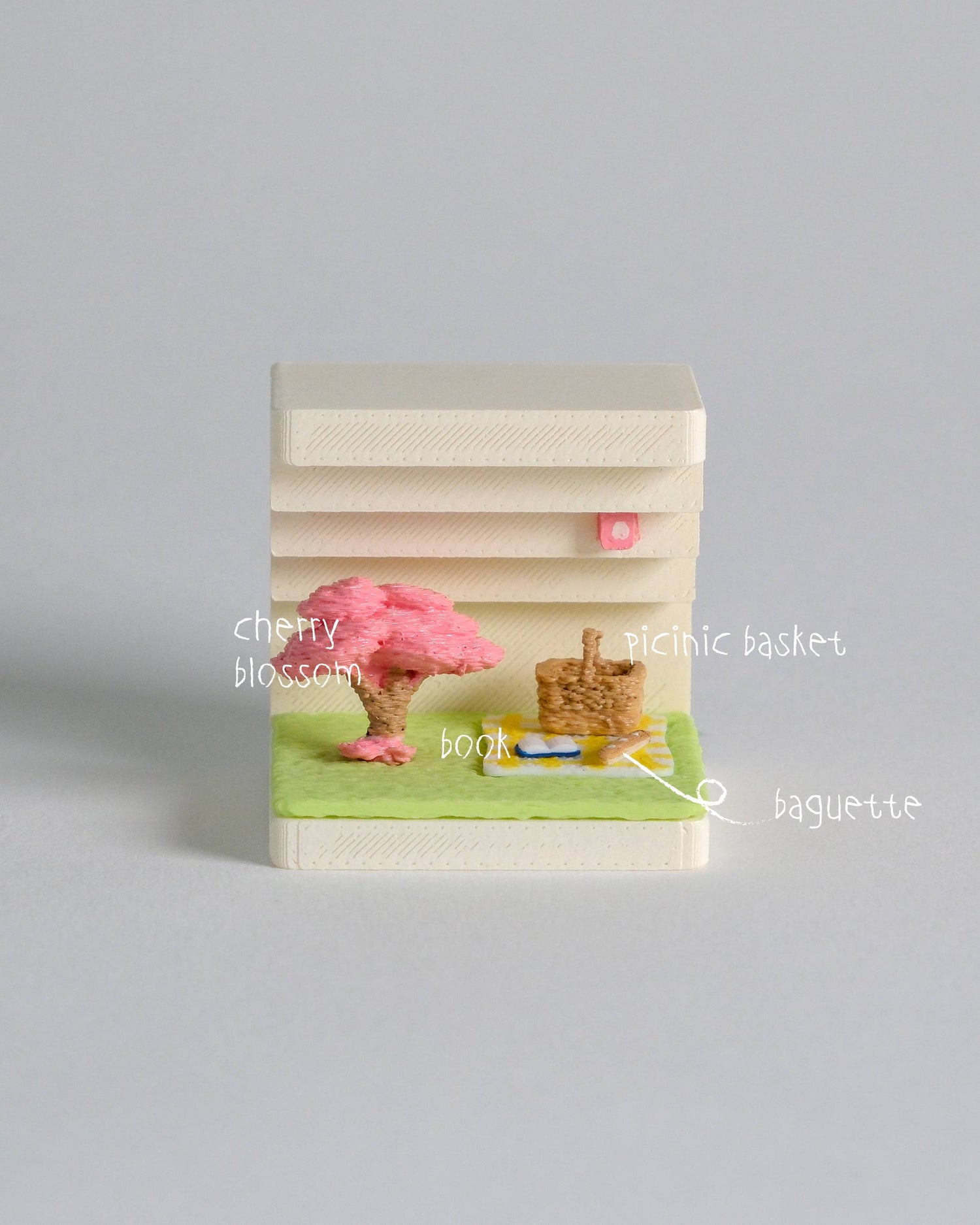 Small book with cherry blossom design on a gray background