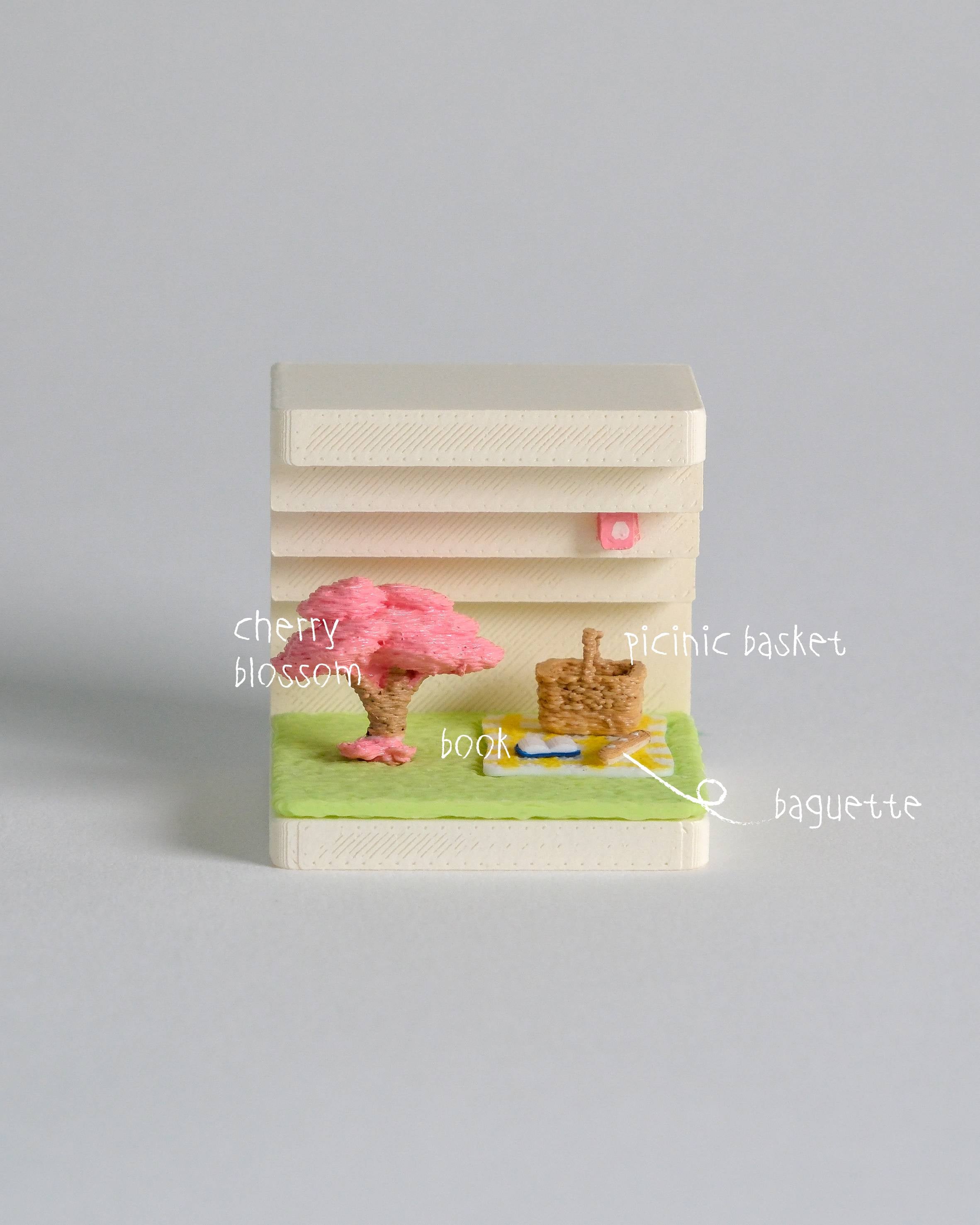 Small book with cherry blossom design on a gray background